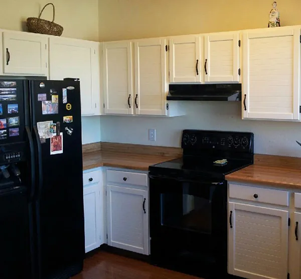 The same kitchen cabinets after painting, in white