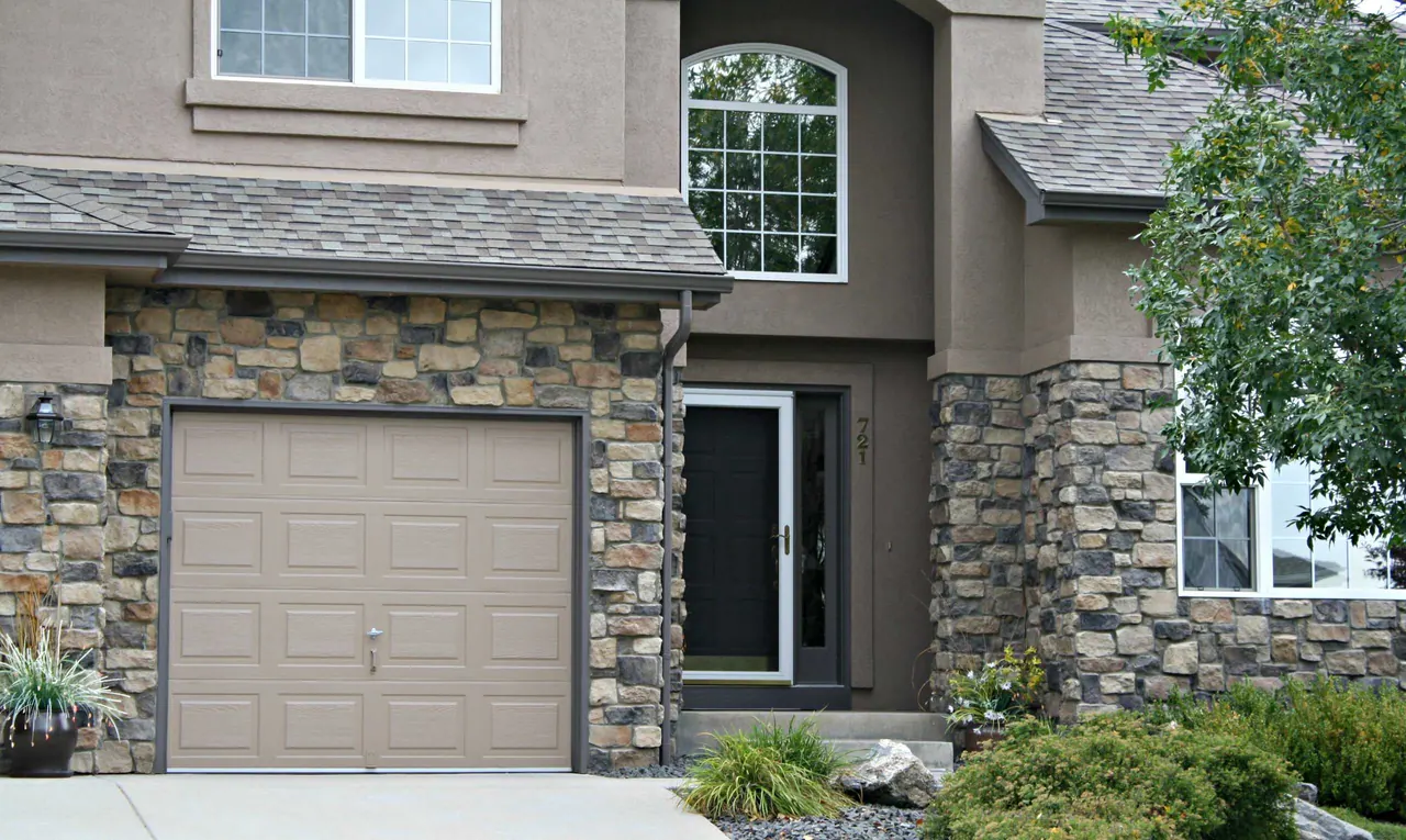Repainted stucco, trim and garage door on a Golden home with stone veneer
