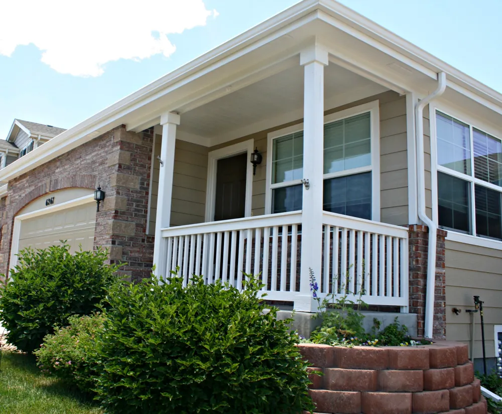 Front porch with white columns and railings